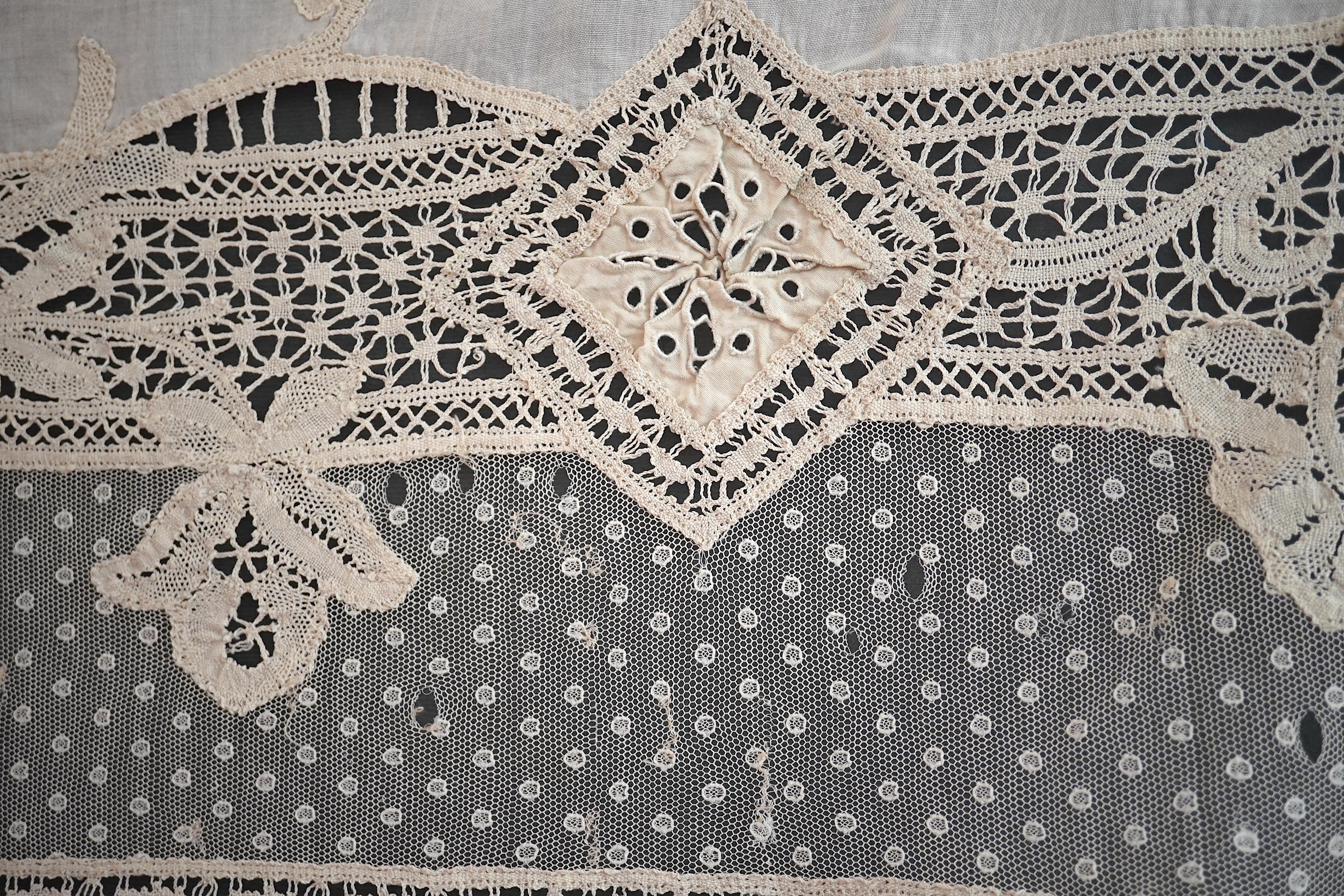 An ornate Edwardian bed cover, handmade from cut work anglaise panels, fine spot motif net and bobbin lace insertions, 228cm wide x 228 cm long. Condition - the spot motif net and fine lawn are damaged in places, the law